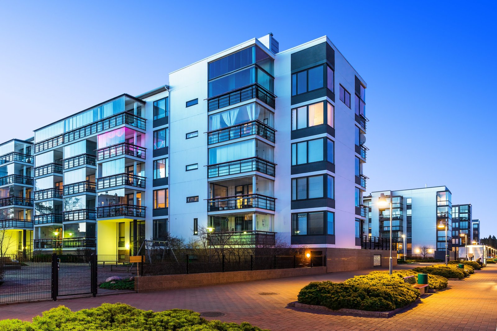Modern real estate A modern multi-family property with similar buildings nearby.
