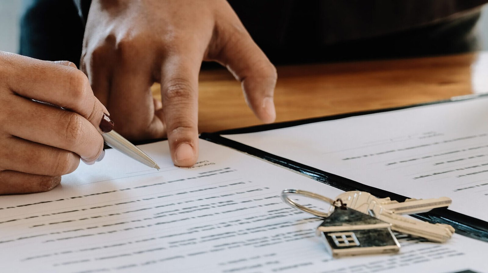 Real estate agent offer hand for customer sign agreement contract signature for buy or sell house. Real estate concept contact agreement concept Real estate agent offer hand for customer sign agreement contract signature for buy or sell house. Real estate concept contact agreement concept.